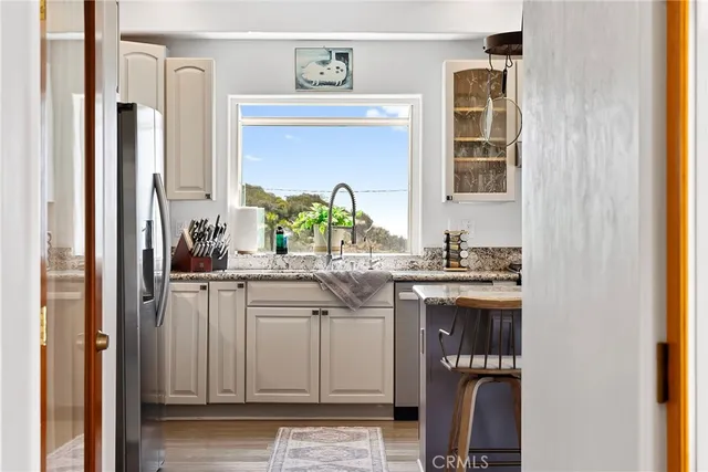 a dining room with a wooden table and chairs