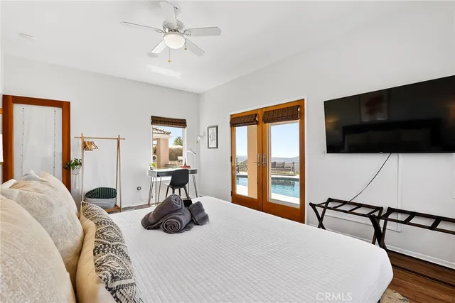 an aerial view of residential houses with outdoor space and trees