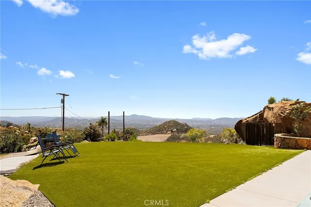 a view of hallway with living room and wooden floor