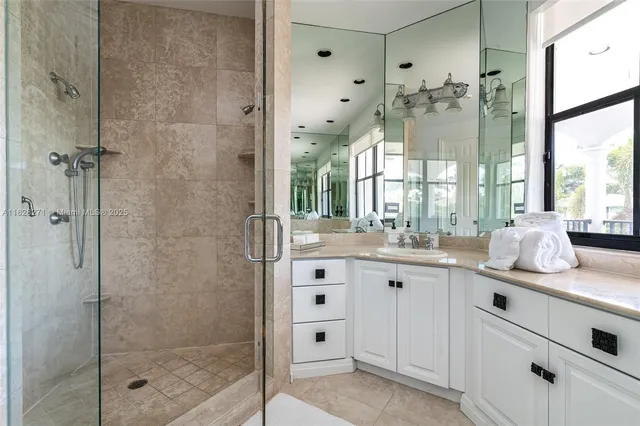 a bathroom with a shower sink and mirror