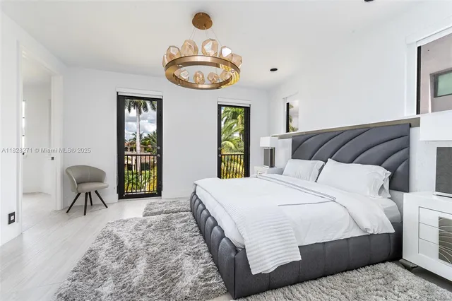 a bedroom with a bed and a chandelier