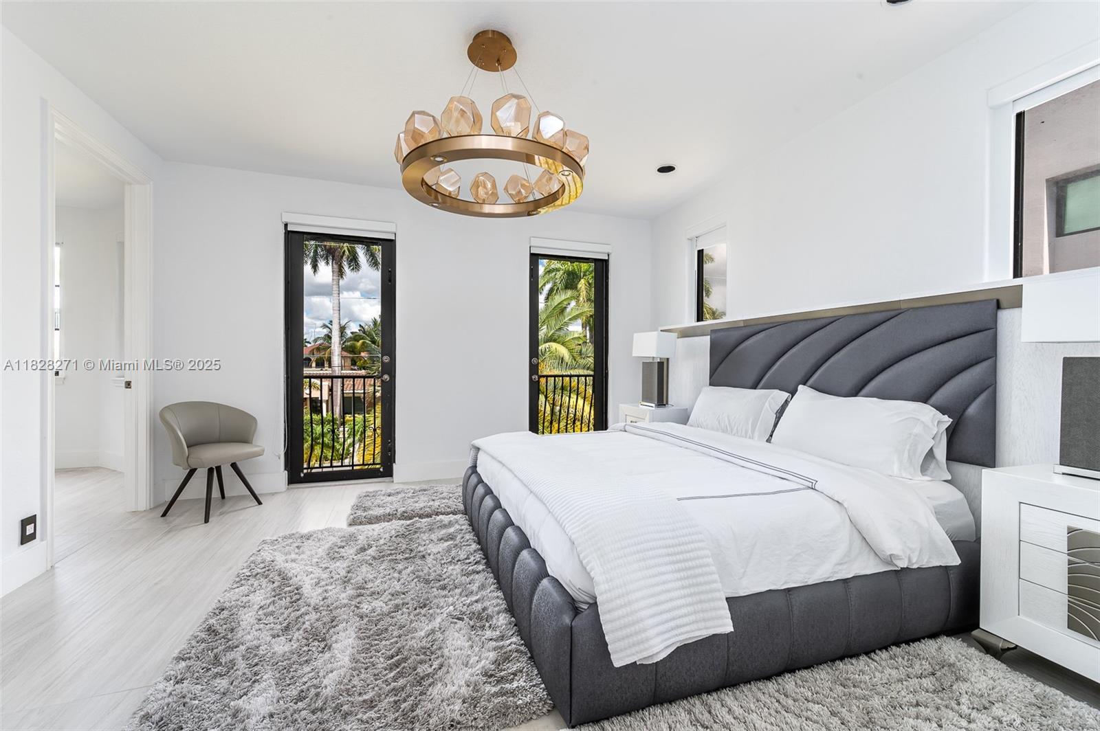 Las Olas Isles Fort Lauderdale, FL 33301 - Photo 21 of 29 a bedroom with a bed and a chandelier