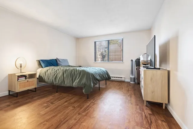 a bedroom with furniture and wooden floor