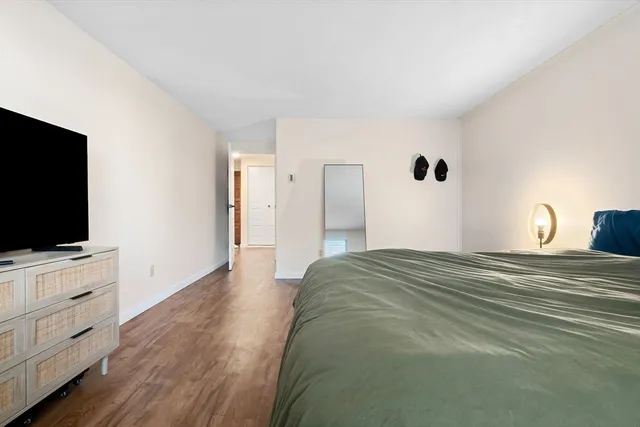 a bedroom with a bed and a flat screen tv