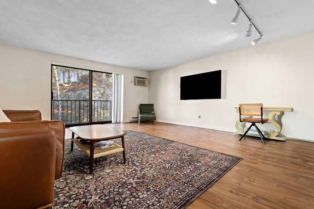 9 Broadway, Unit 210 Saugus, MA 01906 - Photo 4 of 24 a living room with furniture and a flat screen tv