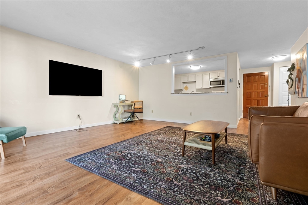 9 Broadway, Unit 210 Saugus, MA 01906 - Photo 5 of 24 a living room with furniture and a flat screen tv