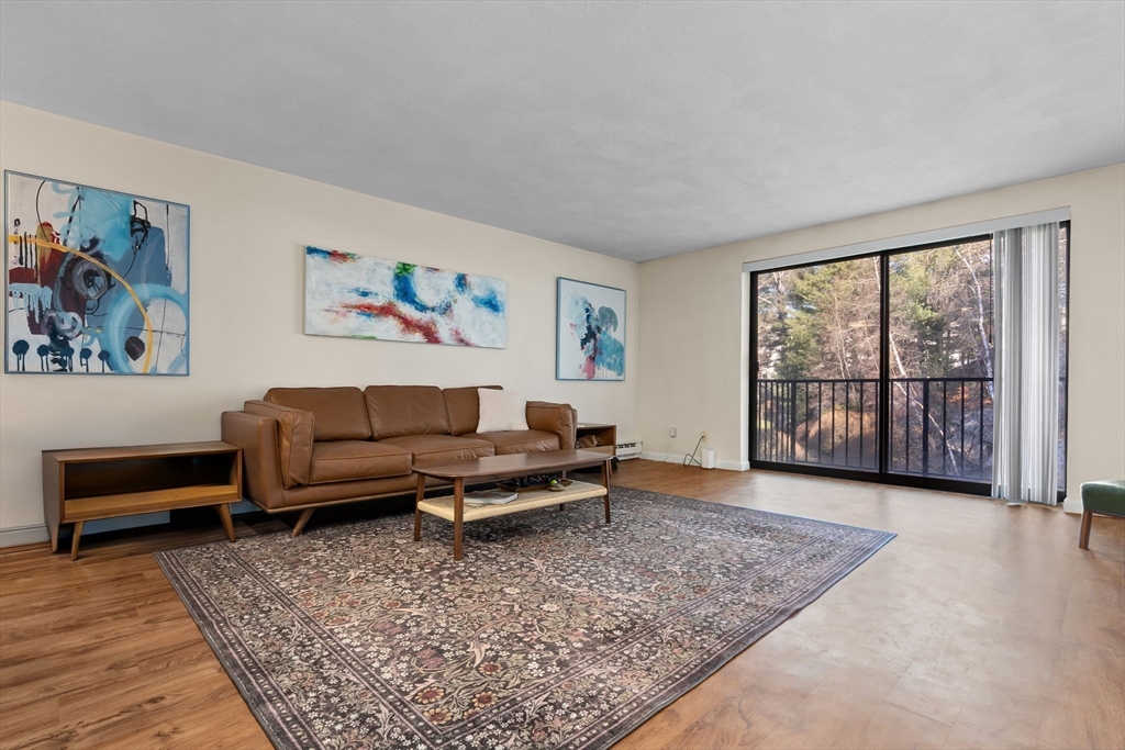 9 Broadway, Unit 210 Saugus, MA 01906 - Photo 6 of 24 a living room with furniture and a floor to ceiling window