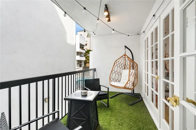 a view of a house with a large window and wooden fence