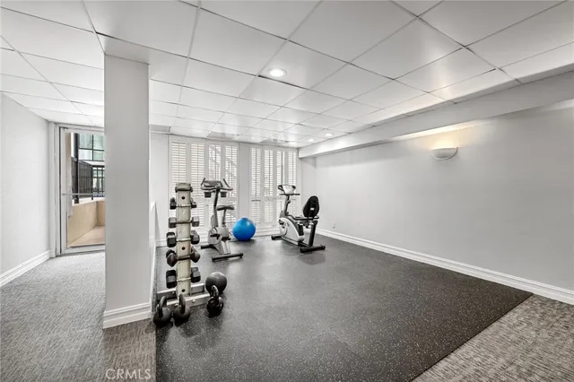 a view of living room filled with furniture and view of kitchen