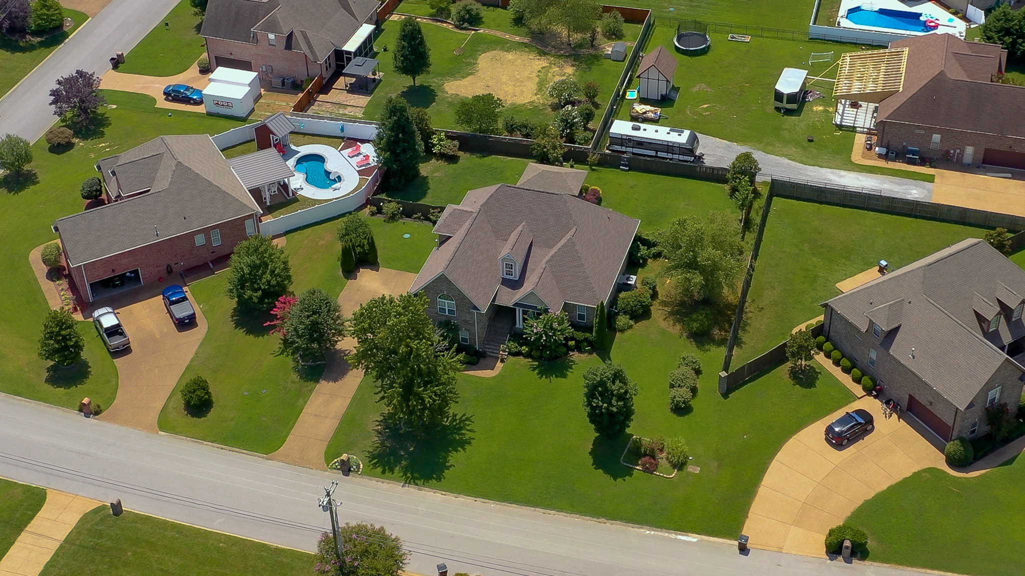727 Heritage Road Lebanon, TN 37087 - Photo 16 of 58 an aerial view of a house with a garden and swimming pool