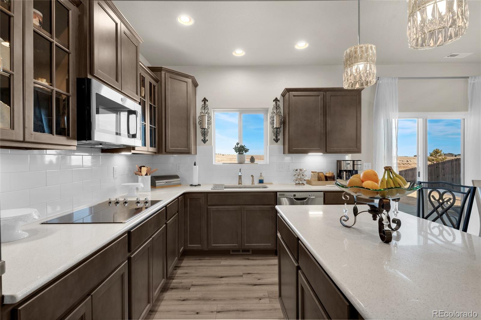 9033 Yellowtail Way Colorado Springs, CO 80908 - Photo 13 of 39 a kitchen with stainless steel appliances a sink stove and cabinets