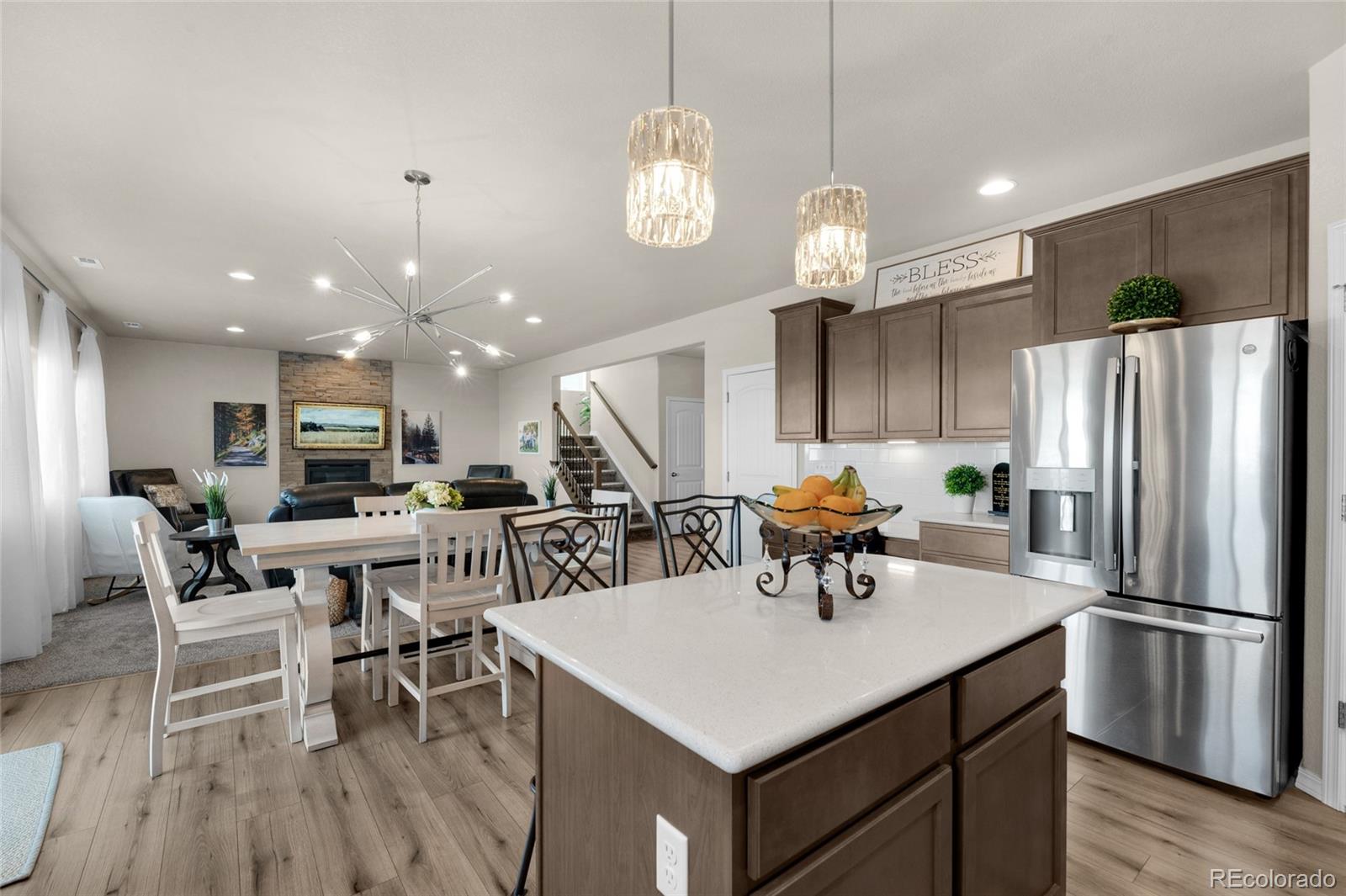 9033 Yellowtail Way Colorado Springs, CO 80908 - Photo 14 of 39 a kitchen with stainless steel appliances a dining table chairs and refrigerator