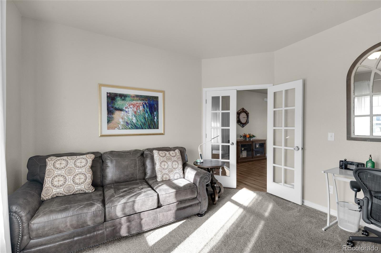 9033 Yellowtail Way Colorado Springs, CO 80908 - Photo 16 of 39 a living room with furniture a walk in closet and a window
