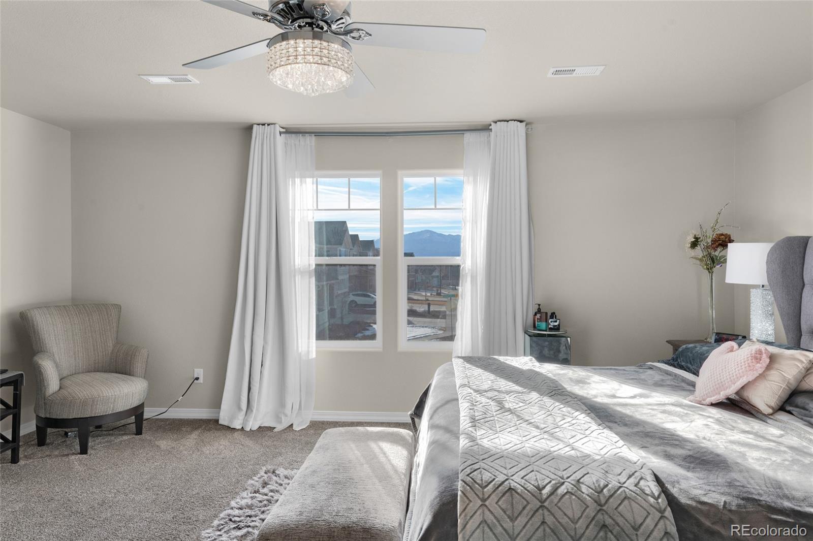 9033 Yellowtail Way Colorado Springs, CO 80908 - Photo 21 of 39 a bedroom with a bed and a chair