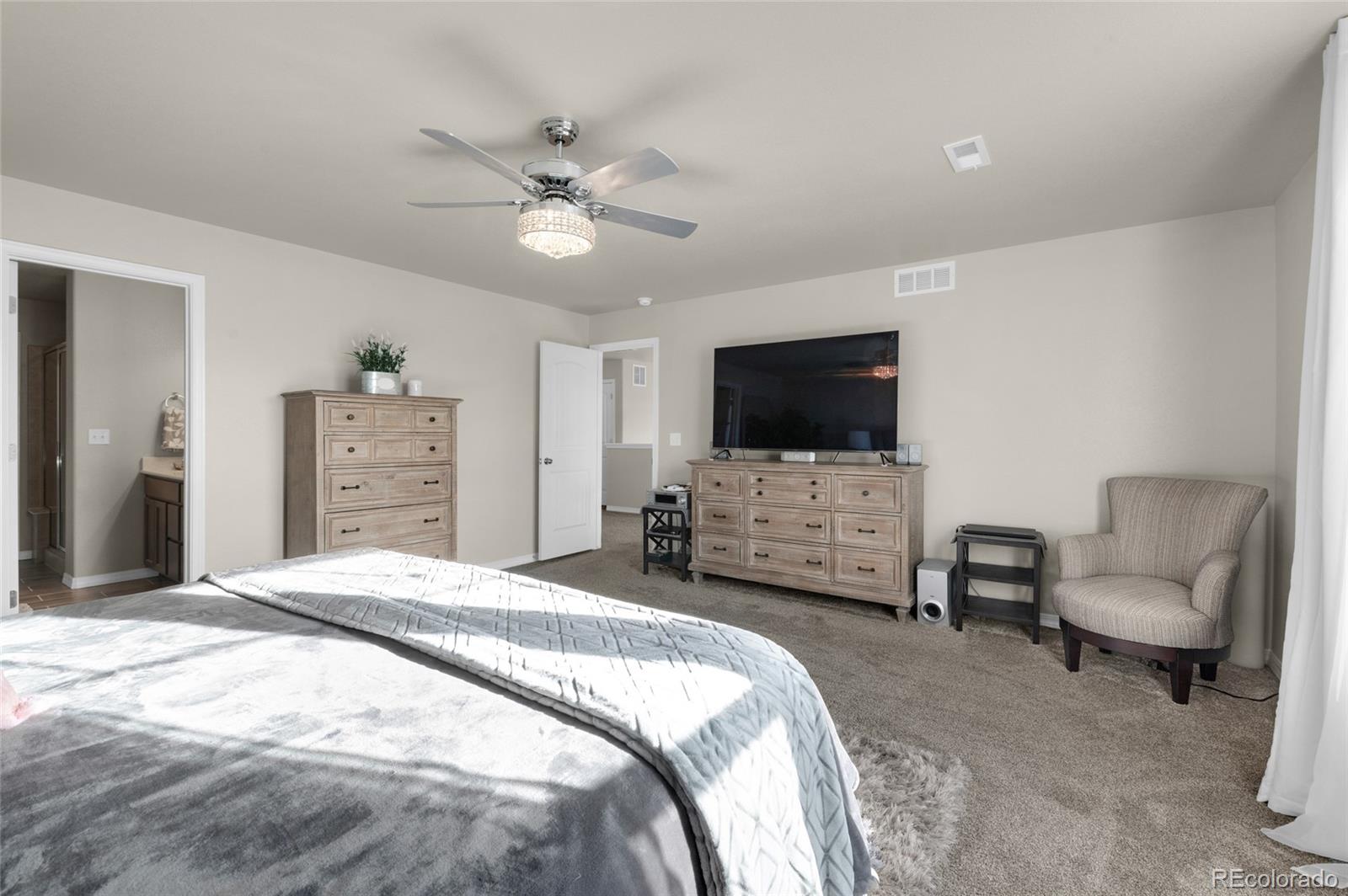 9033 Yellowtail Way Colorado Springs, CO 80908 - Photo 23 of 39 a bedroom with bed tv and chair