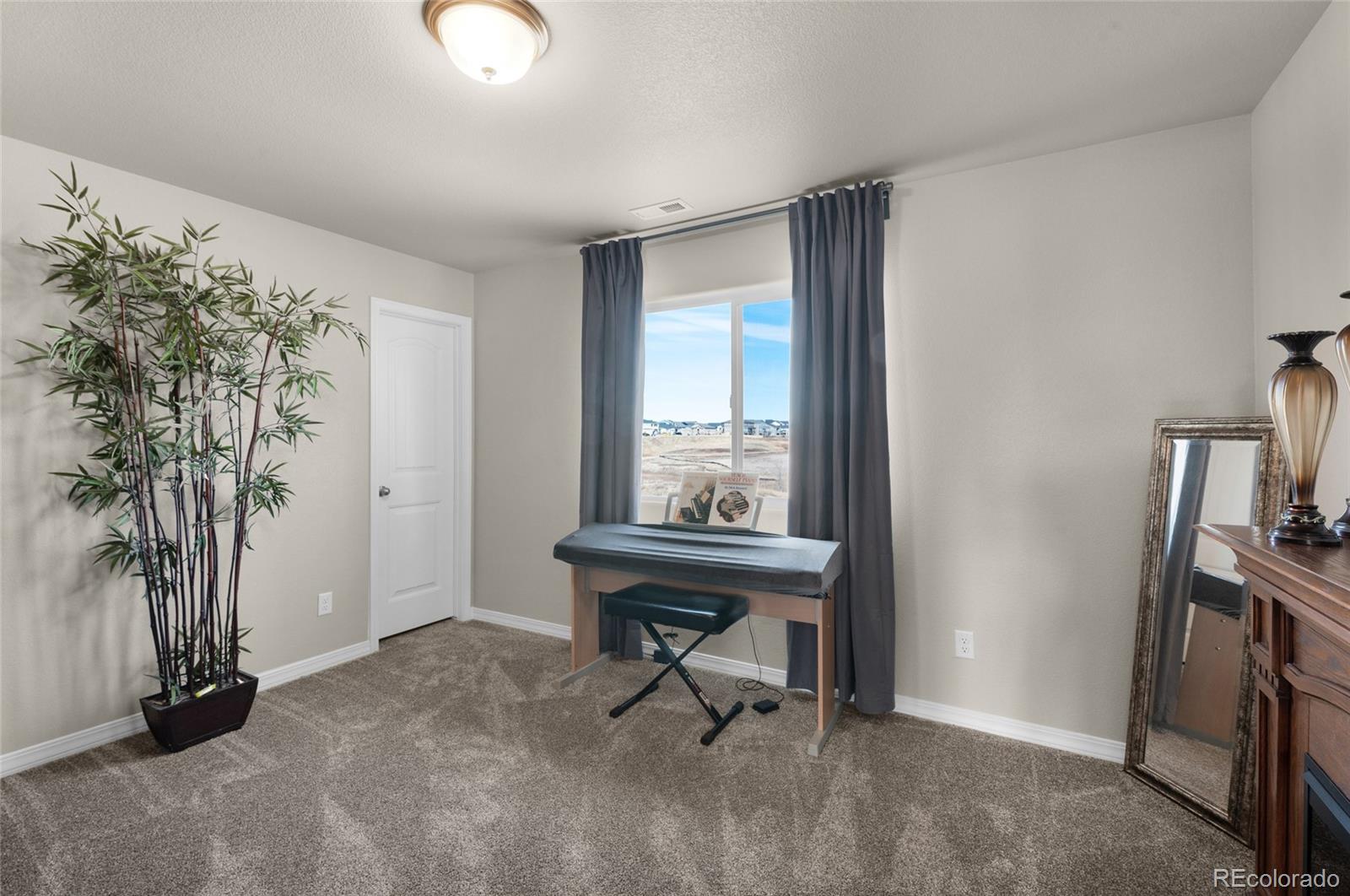 9033 Yellowtail Way Colorado Springs, CO 80908 - Photo 30 of 39 a view of a workspace with furniture and a window