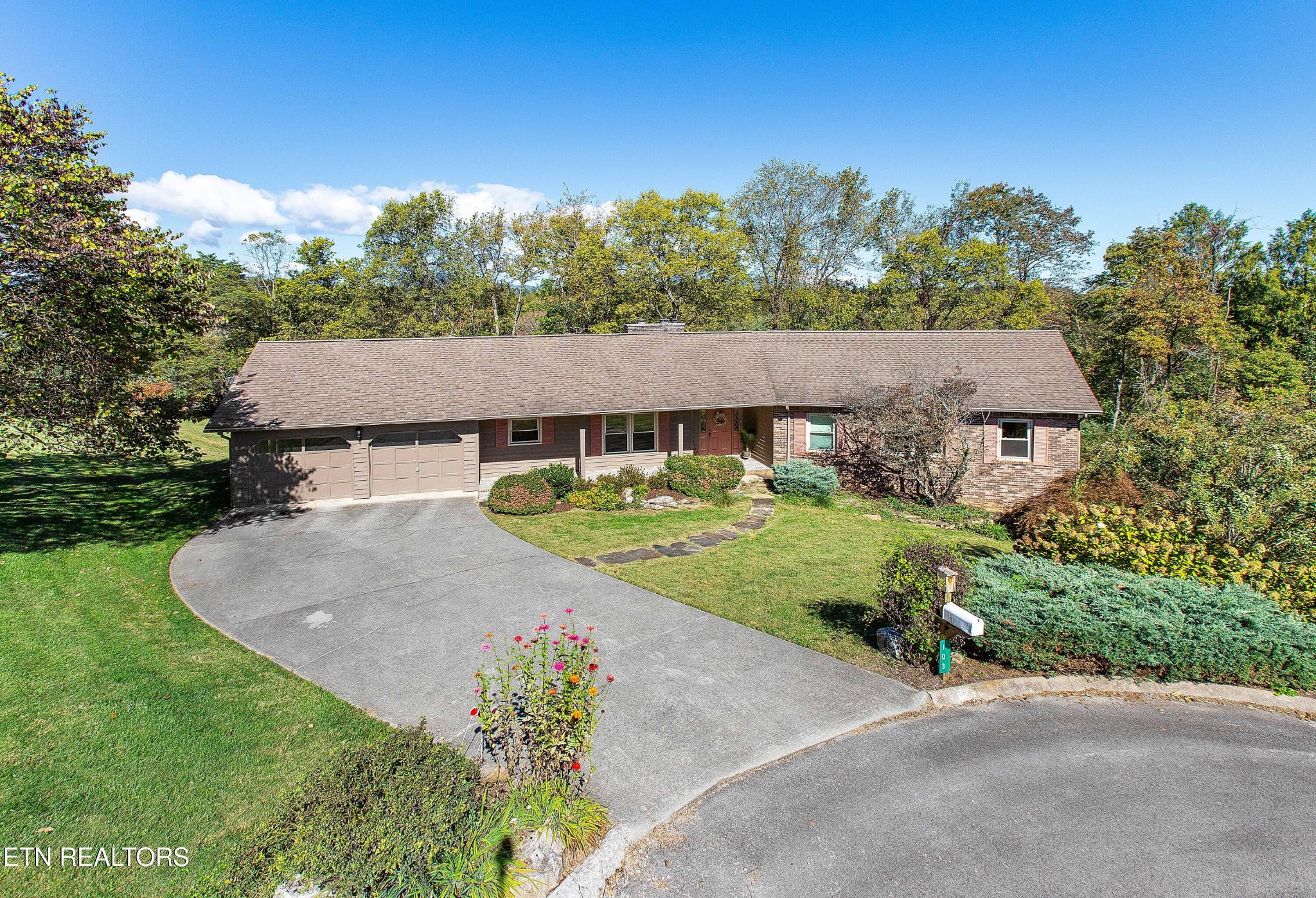 an aerial view of a house with garden space and street view
