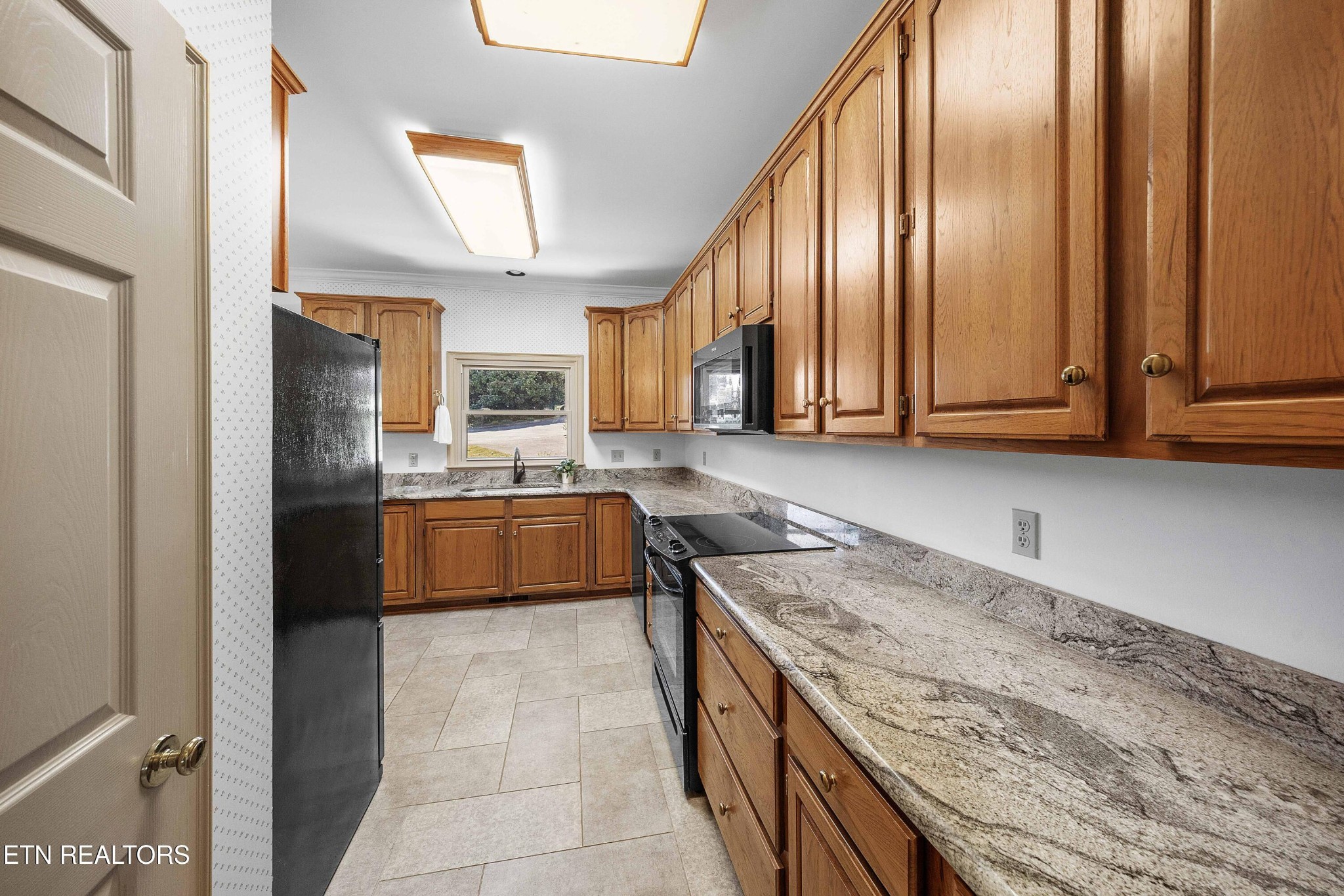 103 Farmington Place Clinton, TN 37716 - Photo 11 of 40 a kitchen with stainless steel appliances granite countertop a stove a sink and a refrigerator