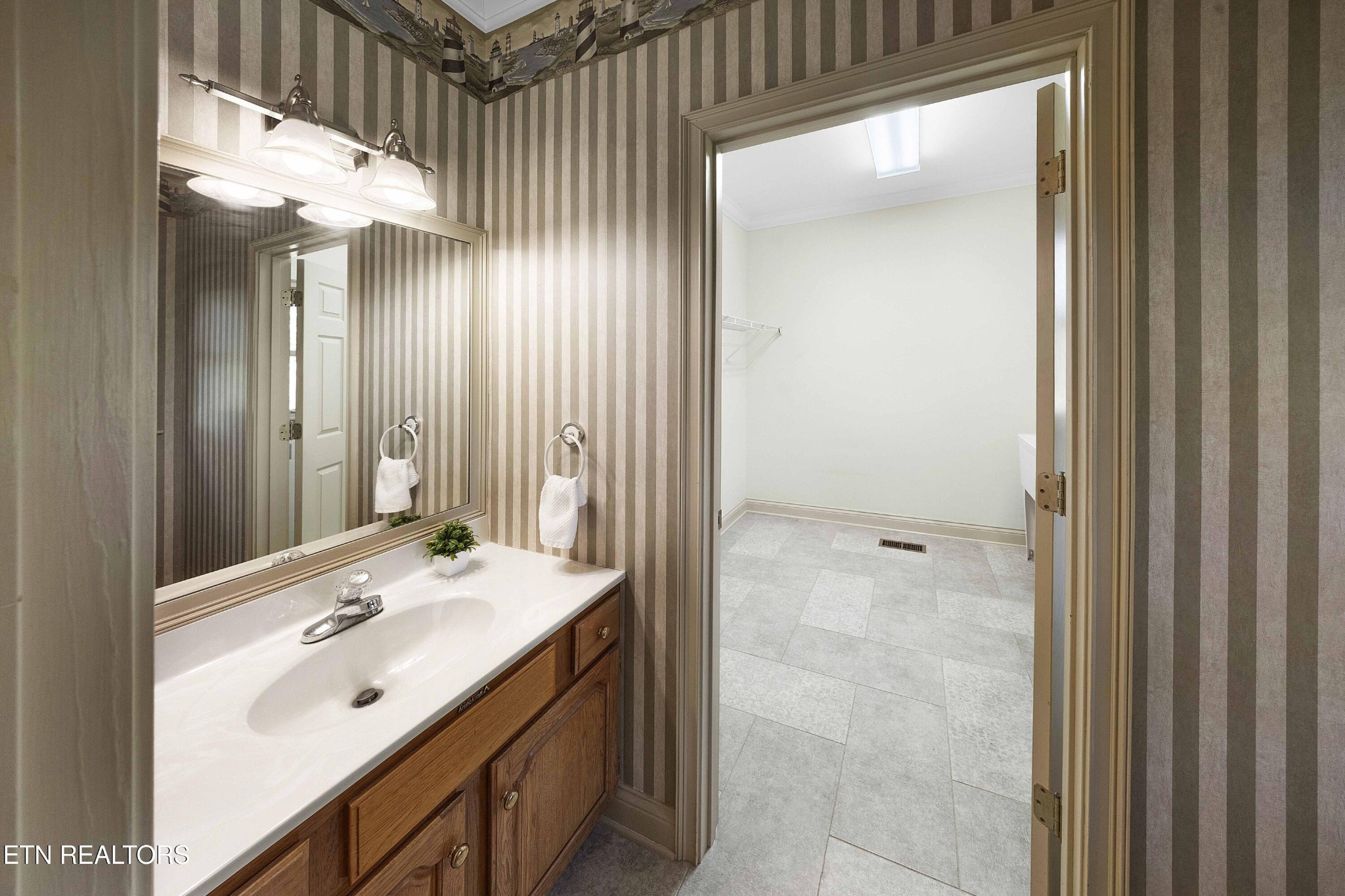103 Farmington Place Clinton, TN 37716 - Photo 13 of 40 a bathroom with a sink a mirror and a shower