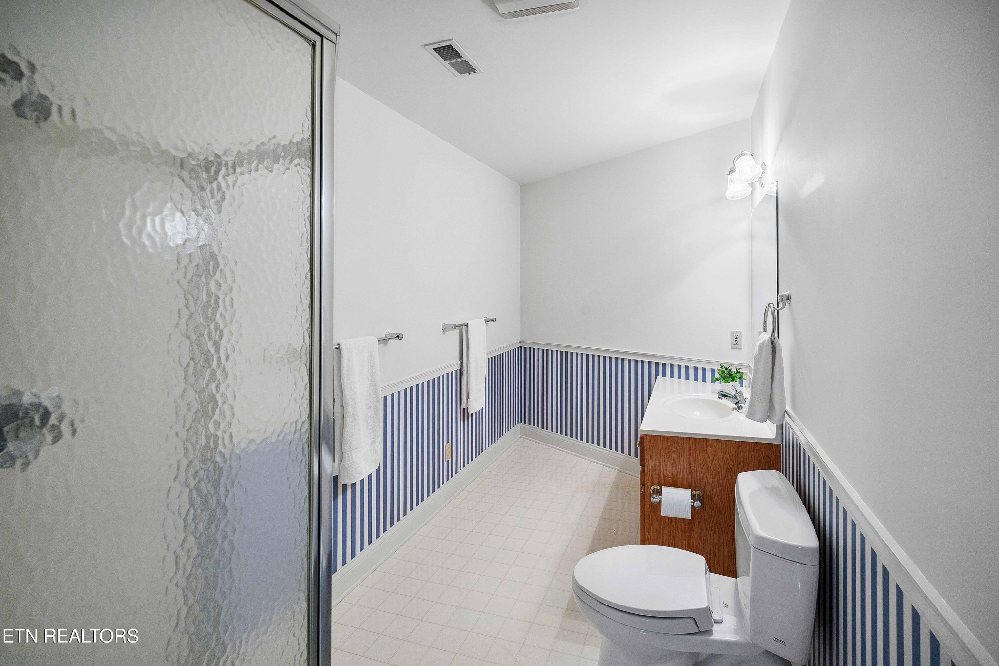 103 Farmington Place Clinton, TN 37716 - Photo 34 of 40 a bathroom with a sink a toilet and shower