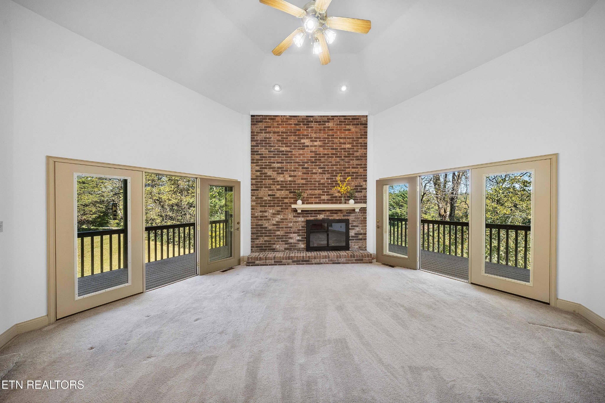 103 Farmington Place Clinton, TN 37716 - Photo 4 of 40 an empty room with floor to ceiling window and an outdoor view