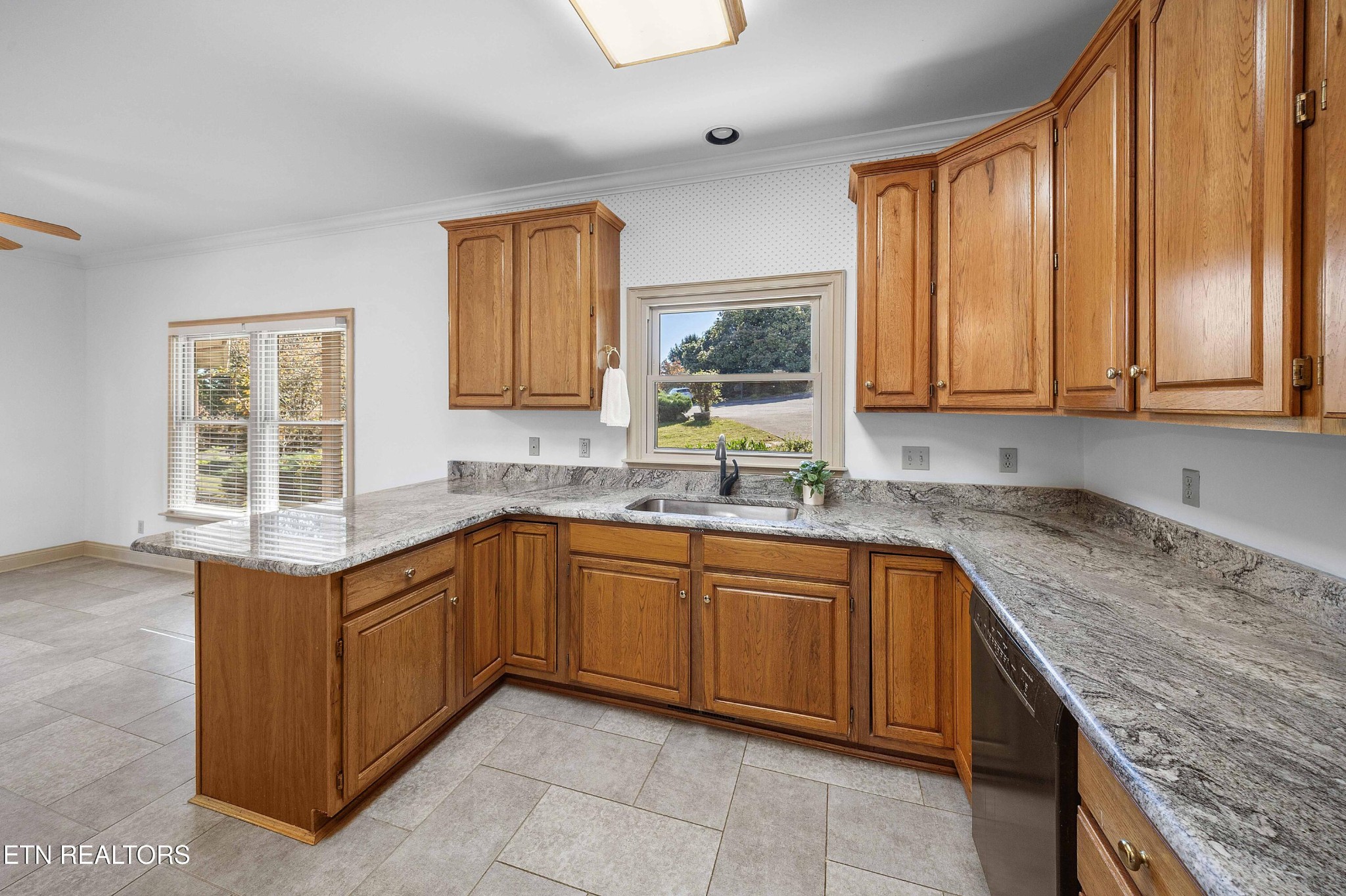103 Farmington Place Clinton, TN 37716 - Photo 7 of 40 a kitchen with granite countertop sink stove and cabinets