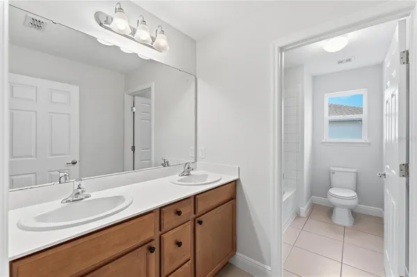 a bathroom with a sink double vanity and a toilet
