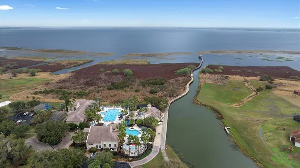 an aerial view of a city with lots of residential buildings ocean and mountain view in back