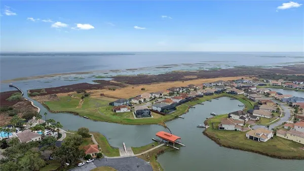 an aerial view of a house with pool lake view and mountain view