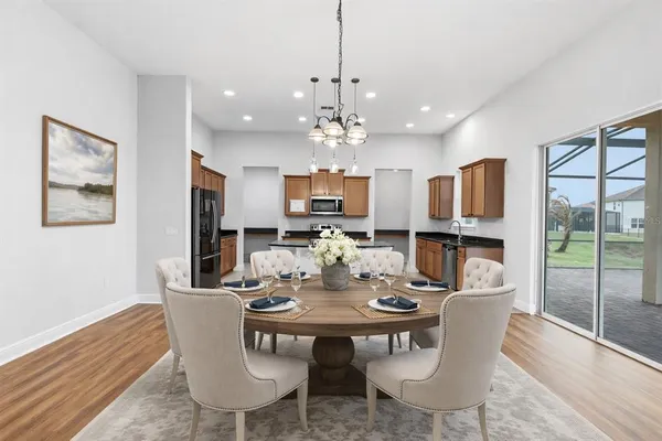 a view of a dining room with furniture wooden floor and chandelier