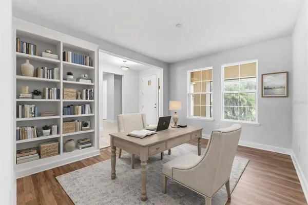 a living room with furniture and a book shelf