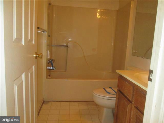 15 Beagle Run, Unit 98 Baltimore, MD 21236 - Photo 13 of 16 a bathroom with a sink a toilet and shower