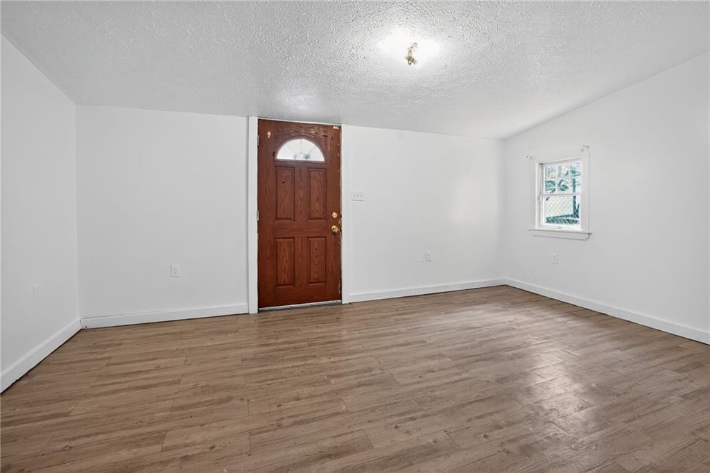 417 Alexander Street McKees Rocks, PA 15136 - Photo 2 of 21 an empty room with wooden floor and windows