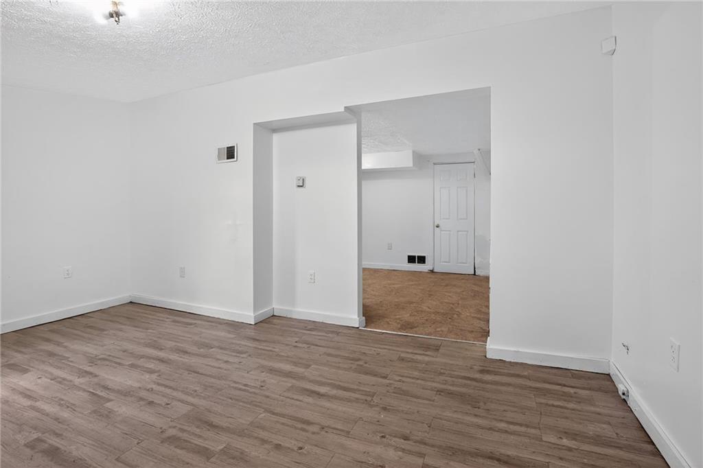 417 Alexander Street McKees Rocks, PA 15136 - Photo 5 of 21 an empty room with wooden floor