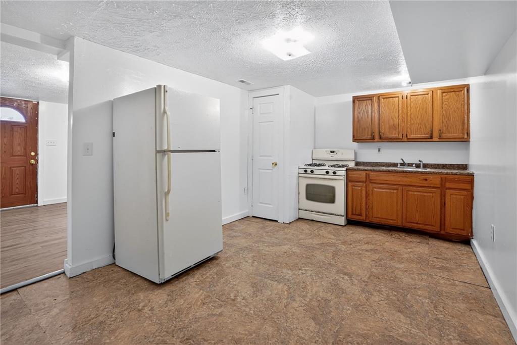 417 Alexander Street McKees Rocks, PA 15136 - Photo 8 of 21 a kitchen with stainless steel appliances a stove sink and refrigerator