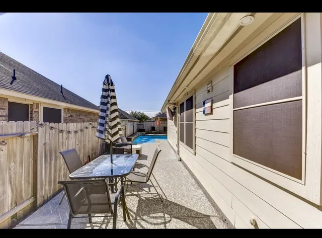 a balcony with table and chairs