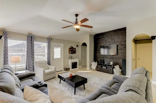 a living room with furniture and a large window