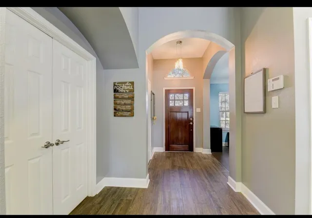 a view of livingroom with wooden floor and front door
