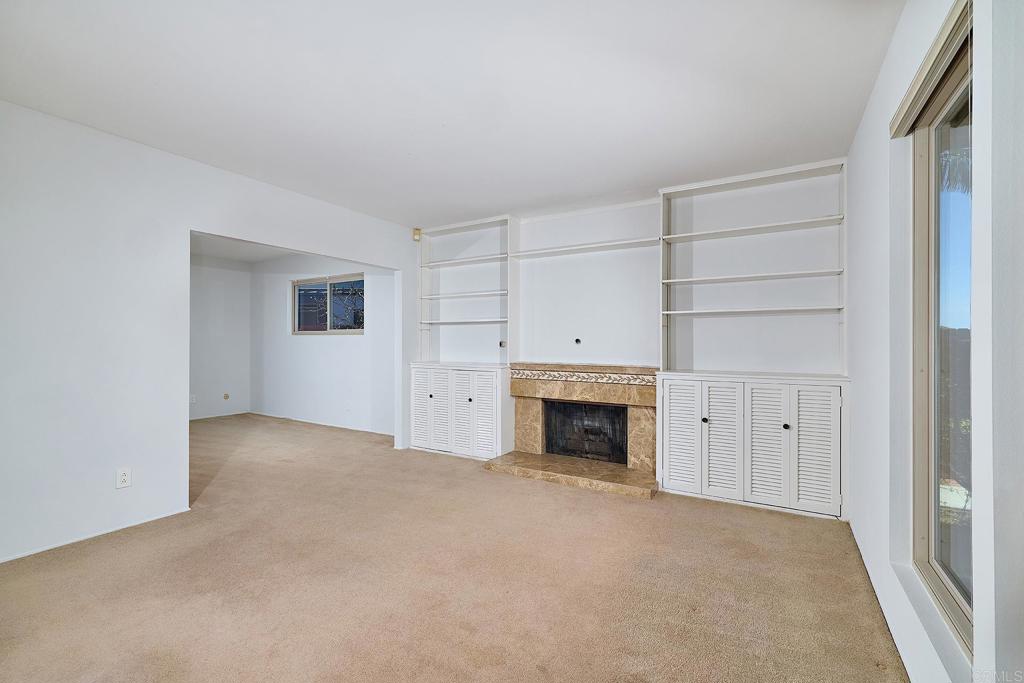 1068 Passiflora Avenue Encinitas, CA 92024 - Photo 11 of 38 a view of an empty room with a fireplace and entryway