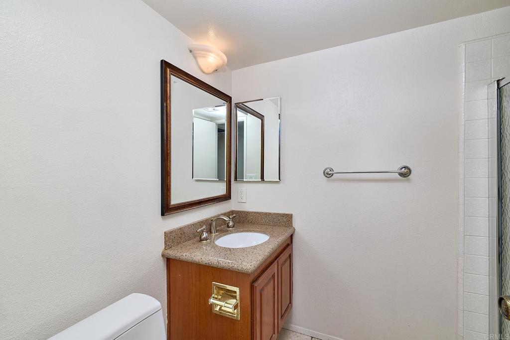 1068 Passiflora Avenue Encinitas, CA 92024 - Photo 13 of 38 a bathroom with a sink toilet and mirror