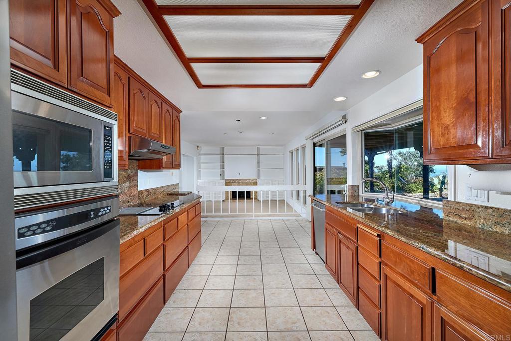 1068 Passiflora Avenue Encinitas, CA 92024 - Photo 8 of 38 a large kitchen with stainless steel appliances granite countertop a stove and a sink