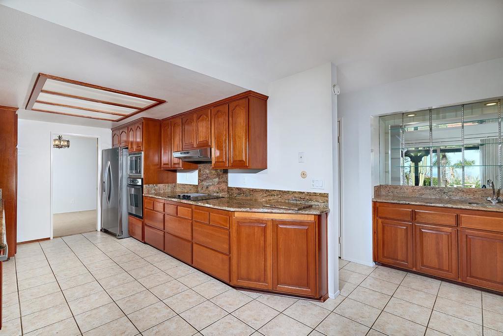 1068 Passiflora Avenue Encinitas, CA 92024 - Photo 9 of 38 a kitchen with stainless steel appliances granite countertop a refrigerator and a sink