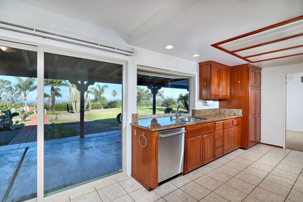 1068 Passiflora Avenue Encinitas, CA 92024 - Photo 10 of 38 a kitchen with stainless steel appliances granite countertop a refrigerator and a sink