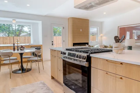 a kitchen with a stove and a refrigerator