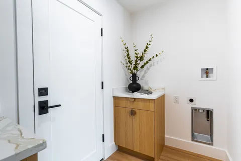 a spacious bedroom with a bed and a chandelier