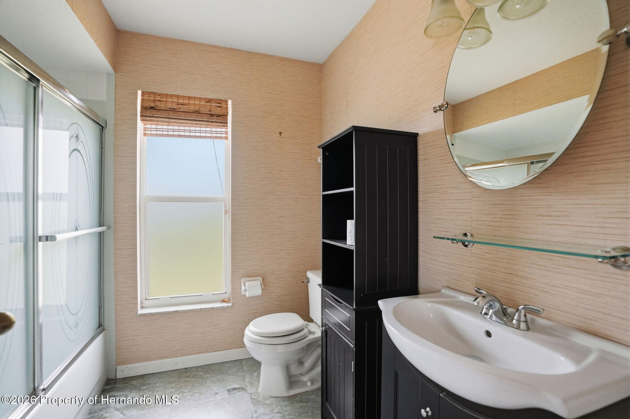 18131 Rivard Boulevard Brooksville, FL 34604 - Photo 37 of 66 a bathroom with a sink toilet and shower