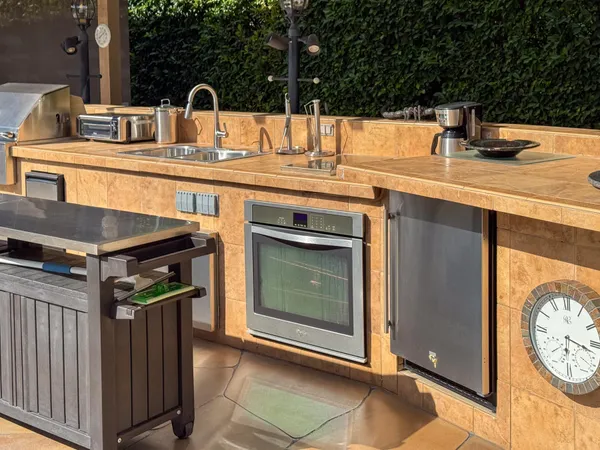 a kitchen with stainless steel appliances granite countertop a sink and a stove top oven