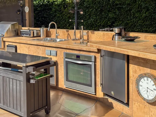 a kitchen with stainless steel appliances granite countertop a sink and a stove top oven