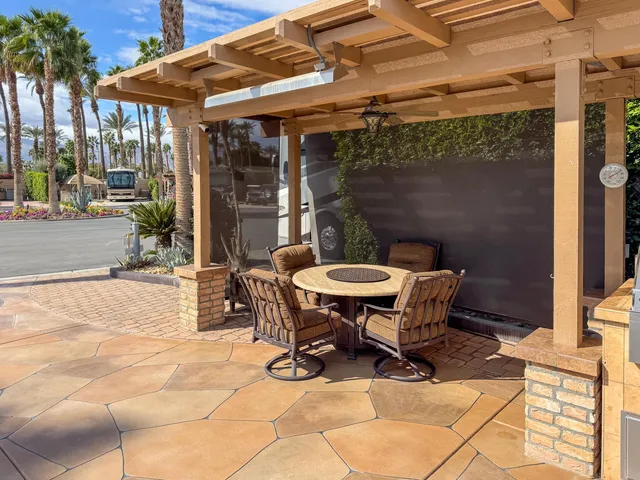 a outdoor space with a table and chairs