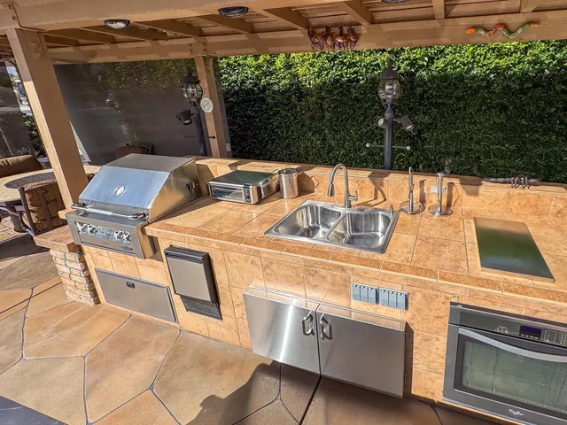 a view of a patio with table and chairs with wooden floor and fence